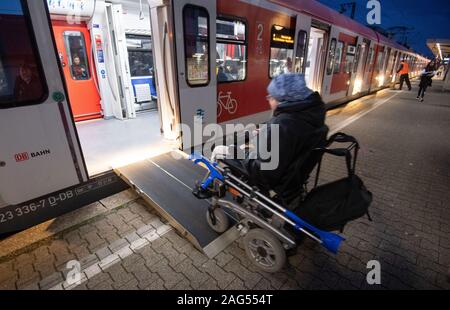 Ludwigsburg, Deutschland. 17 Dez, 2019. Steffen Gödecke Antriebe mit seinen elektrischen Rollstuhl über eine Rampe in eine S-Bahn an der Station an. Auf einer Pressekonferenz am 18. Dezember, die wichtigsten Punkte der staatlichen Initiative "Bahnhof der Zukunft" vorgestellt werden. Ziel der Initiative ist es, Bahnhöfe in Barrierefreie Mobilität Hubs zu entwickeln. Credit: Marijan Murat/dpa/Alamy leben Nachrichten Stockfoto