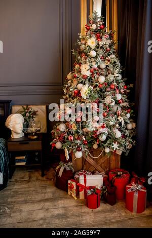 Schöne Ferienwohnung Zimmer dekoriert mit Weihnachtsbaum mit Geschenken unter ihm Stockfoto