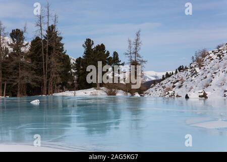 Altai Gebirge zugefrorenen See mit großen Steinen Stockfoto