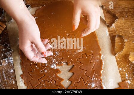 Der Prozess der Backen Schokolade Cookies, verschiedene Formen. Indigrens auf dem Tisch, die Hände der Konditor, Desserts, festliche Cookies. Stockfoto