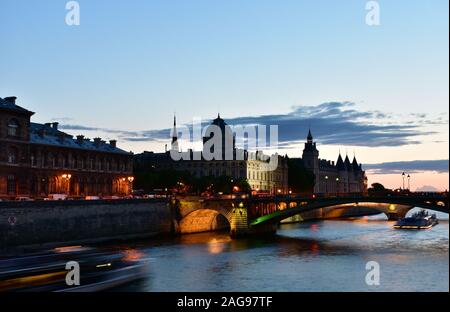 La Conciergerie und der Sainte Chapelle spire von Seine River Bridge bei Sonnenuntergang. Paris, Frankreich. Stockfoto