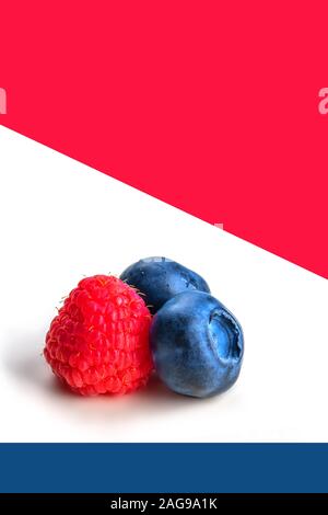 Heidelbeeren und Himbeeren auf weißen, blauen und roten Hintergrund. Nahaufnahme, Ansicht von oben, hohe Auflösung. Ernte Konzept Stockfoto