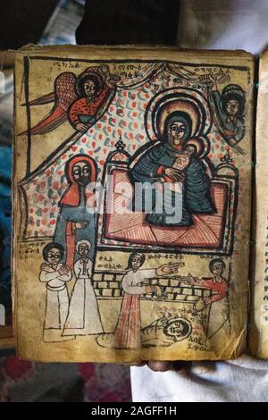 Äthiopien, Amhara-region, Lalibela, Arbatu Chirkos Ensessa, Biblia, alte Felsen gehauene Kirche, Priester, 800 Jahre alten beleuchteten Evangelium zeigen na Stockfoto