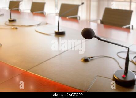 Mikrofon auf einem Holztisch und leere Stühle in einem Sitzungssaal. Business Konzept Stockfoto