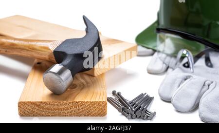Nahaufnahme eines Zimmermanns hammer, Helm und Schutzhandschuhe aus Leder auf einem weißen Hintergrund. Industrie Bau, Arbeitssicherheit. Stockfoto