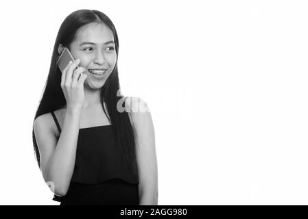 Junge glücklich Asiatischen Teenager, am Telefon zu sprechen Stockfoto