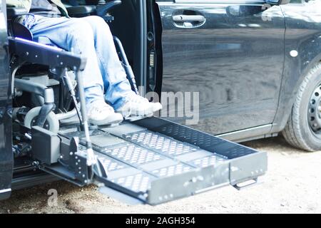 Behinderte Menschen im Rollstuhl auf der Hebebühne Stockfoto