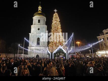 Kiew, Ukraine. 19 Dez, 2019. Die ukrainer besuchen Zeremonie der Beleuchtung der Weihnachtsbaum der Ukraine an der Hagia Sophia in Kiew, Ukraine, am 19. Dezember 2019. Die wichtigsten Weihnachtsbaum der Ukraine von 26 Metern verfügt über Tausend Christbaumschmuck. Die wichtigsten Weihnachtsbaum mehr als 20 Meter hoch ist, mit 1000 Spielzeug und ca. 4 km von bunten Lichtgirlanden geschmückt, nach Medien. Credit: Serg Glovny/ZUMA Draht/Alamy leben Nachrichten Stockfoto