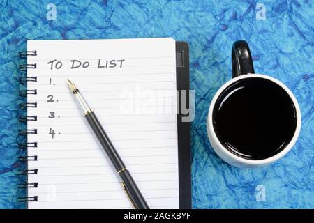 To-Do-Liste geschrieben auf einem Buch mit Stift und Kaffeetasse Stockfoto