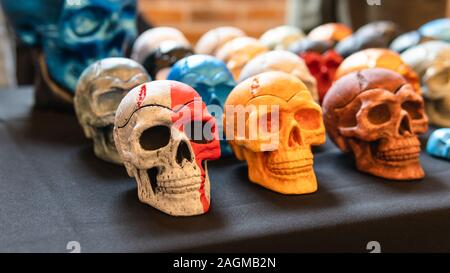 Eine Sammlung von bunten Keramik Schädel, close-up. Bemalte Schädel für Halloween und mexikanischen Tag der Toten Dekoration. Stockfoto