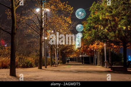 London, England, Großbritannien - November 21, 2019: Fußgänger entlang der Allee der Bäume im Herbst an Tessa Jowell Boulevard im Londoner Olympic Park. Stockfoto