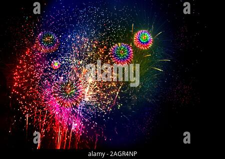 Bunte Rot, Orange, Blau, Grün und Gelb Feuerwerk gegen Black Sky Stockfoto