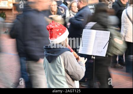 Kiel, Deutschland. 21 Dez, 2019. Ein Mädchen spielt Weihnachtslieder auf Ihrem Recorder in der vorweihnachtlichen Hektik in einer Fußgängerzone. Credit: Carsten Rehder/dpa/Alamy leben Nachrichten Stockfoto