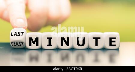 Hand verwandelt einen Würfel und Änderungen zuerst der Ausdruck "Minute", "last minute". Stockfoto