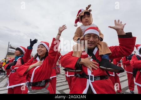 Die Teilnehmer warm-up vor der Teilnahme an der Tokyo große Santa Run in Komazawa-daigaku Olympic Park, Tokio, Japan. Sonntag 22. Dezember 2019, die grosse Santa Run wurde zum ersten Mal in Tokio im Jahr 2018 laufen. Diese Jahre sahen über 3.000 Menschen in Santa Kostüme laufen und gehen Sie ein 4,3 Kilometer Kurs Geld für medizinische Nächstenliebe in Japan und Wasser Projekte für den Massai in Kenia zu erhöhen. Stockfoto