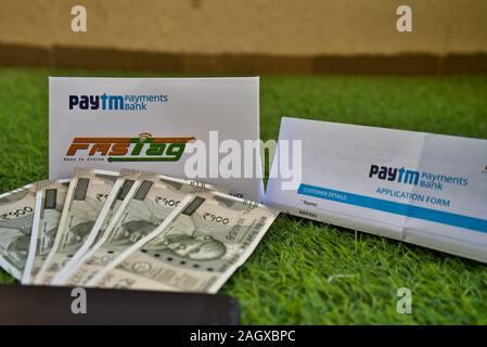 Fast Tag und das Antragsformular von PayTM Zahlung Bank auf grünem Gras zusammen mit Banknoten Stockfoto