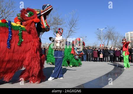 Yongdeng, China. 22 Dez, 2019. Folk Künstler proben Lion Dance für die bevorstehende chinesische Mondjahr in Yongdeng County, Lanzhou, der Hauptstadt der Provinz Gansu im Nordwesten Chinas, Dez. 22, 2019. Lion Dance ist eine traditionelle darstellende Kunst Chinas. Yongdeng Lion Dance, ein lokaler Stil von Lion Dance für seine unverwechselbare und komplizierte Bewegung bekannt, wurde als die immateriellen Kulturerbes der Provinz Gansu im Jahr 2011 aufgeführt. Der Löwe Kostüm, von Holzleisten im Inneren, ist etwa 2,8 Meter lang und 1,8 Meter hoch, so dass der Tanz eine anspruchsvolle Aufgabe für Künstler unterstützt. Quelle: Xinhua/Alamy L Stockfoto