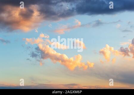 Wunderschöne goldene Wolke in einem blauen Himmel kurz vor Sonnenuntergang. Einen malerischen Sonnenuntergang cloudscape für Hintergrund. Nachleuchten des Sonnenuntergangs. Schönheit in der Natur. Stockfoto