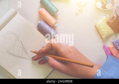 Frau zeichnet Konzept in Ihre Werkstatt. Flach Stockfoto
