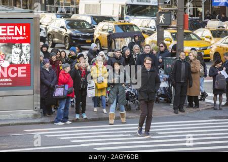 Fußgänger Kreuz 42nd Street auf der 5th Avenue am Schwarzen Freitag zum Auftakt der Holiday Shopping Season in New York City. Stockfoto