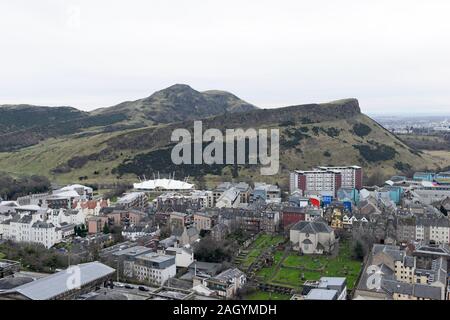 Blick vom Calton Hill dem Holyrood Park und die Salisbury Crags in Edinburgh, Schottland, Großbritannien, mit dem Dynamic Earth Center am Fuße des Hügels. Stockfoto