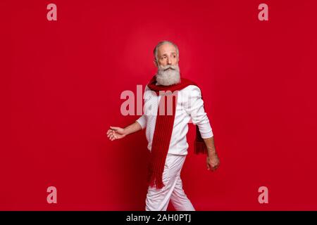 Portrait der noblen pensionierter Mann, bekleidet mit weißen Pullover Hosen Hosen isoliert über den roten Hintergrund Stockfoto