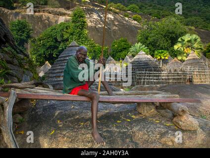 Lotuko Stamm Mann ruht auf einem Bett aus Holz, Central Equatoria, Illeu, South Sudan Stockfoto