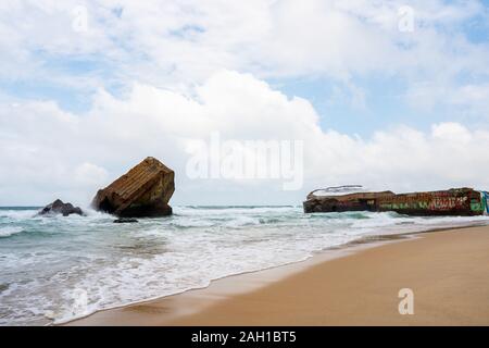 Beton Bunker aus Kriegszeiten Vergangenheit in Shorebreak auf Französisch Strand Stockfoto