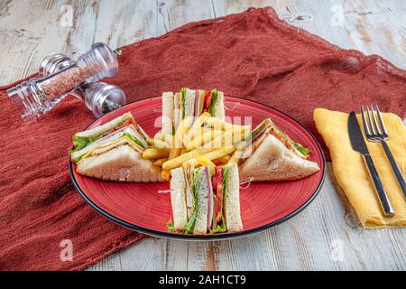 Amerikanische Lebensmittel - klassischen Club Sandwich mit Pommes Frites. Club Sandwich Restaurant Konzept. Stockfoto