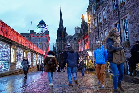 Edinburgh, Schottland, Großbritannien. 23. Dez 2019. Weihnachtsbeleuchtung und voll mit Touristen, die sich in der Royal Mile in der Abenddämmerung Ansätze. Blick auf die Camera Obscura. Quelle: Craig Brown/Alamy leben Nachrichten Stockfoto