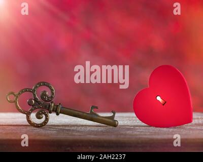 Valentinstag Konzept. Kleine, rustikale Rotes Herz mit alten Schlüssel auf hölzernen Tisch Stockfoto