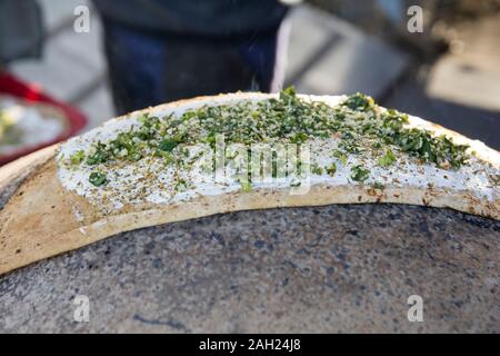 Traditionelle Drusen Pita Brot, gebacken in einem Metall Saj oder Tava, mit 'Labane' Käse, eine Middetrenian angespannt Joghurt und grünes Tabbouleh Salat Stockfoto