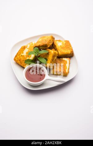 Amritsari Paneer Tikka aus Quark Würfel in einem Teig mit Besan, Chat Masala und Gewürze getaucht und flach in Pfanne gebraten, serviert mit Witz Stockfoto