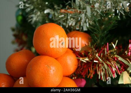 Mandarinen auf dem Hintergrund der Weihnachtsbaum Stockfoto