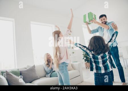 Foto von jungen Förderung der Familie zwei Kinder Hände Luft erhalten Sie unerwartete Geschenkset froh besten Eltern zu haben Stockfoto
