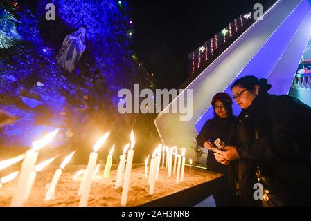 Guwahati, Assam, Indien. 24 Dez, 2019. Devotees Kerzen an Heiligen Johns Kirche, am Vorabend von Weihnachten in Guwahati. Quelle: David Talukdar/ZUMA Draht/Alamy leben Nachrichten Stockfoto