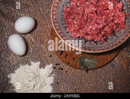 Hackfleisch in eine Platte, Eier und Mehl. Das Kochen von Essen. Rezepte Fleischgerichte. Kochen Stockfoto