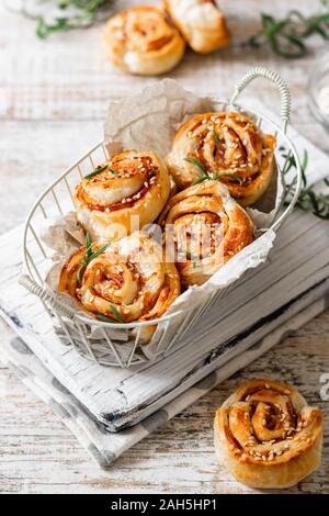 Ungezuckerte Schnecken und Blätterteig mit Speck und Sesam. Komfortable und einfache Speisen. Stockfoto