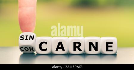 Hand einen Würfel und Änderungen der Ausdruck "con carne' in Carne', oder umgekehrt. Stockfoto