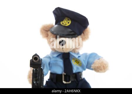 Polizei und Waffen Konzept. Niedlichen Teddybären in Polizeioffizier einheitliche Holding Pistole vor weißem Hintergrund Stockfoto