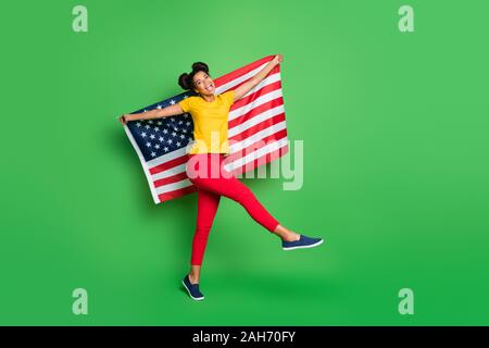 Volle Länge Foto von erstaunlich dunkle Haut Dame feiert Unabhängigkeit, usa Tag Nationalflagge auf Parade marsh Verschleiß casual Gelb t-shirt Rot Pa Stockfoto