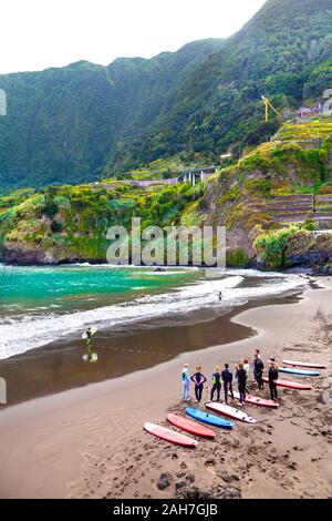 Eine Gruppe von Menschen mit Surfbrettern, stehend auf einem Strand, Surfen, Seixal, Madeira, Portugal Stockfoto