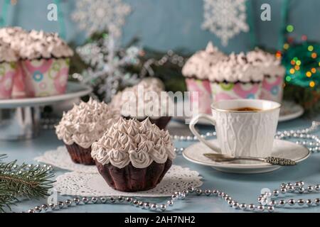 Hausgemachte Schokolade Kuchen mit Sahne und eine Tasse Kaffee auf einem hellblauen Hintergrund angeordnet, horizontale Ausrichtung, festliche Still Life Stockfoto