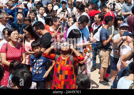 26.12.2019, Singapur, Republik Singapur, Asien - Menschen bei Kebun Baru Federn Amphitheater sammeln die ringförmige Sonnenfinsternis zu beobachten. Stockfoto