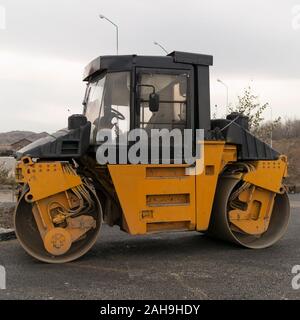 Asphalt-Rollen auf der Straße. Starke Vibrationen der Rollen. Stockfoto