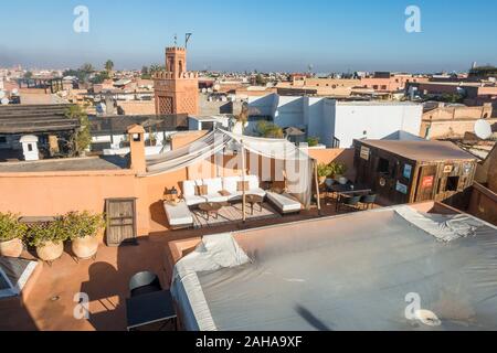 Dachterrasse mit Stühlen in einem Riad, Marrakesch Skyline in Medina, Marrakesch-Safi Region, Marokko, Nordafrika. Stockfoto