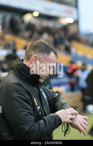 Mansfield, Nottinghamshire, Großbritannien. 26. November 2019. Mansfield Stadt manager ‎Graham Coughlan im dugout an einem Mansfield Town Call Stadion. Stockfoto