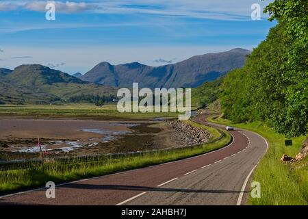 Classic Lotus fahren entlang einer kurvigen Straße neben dem Fluss Kishorn, mit Beinn Damh im Hintergrund Stockfoto