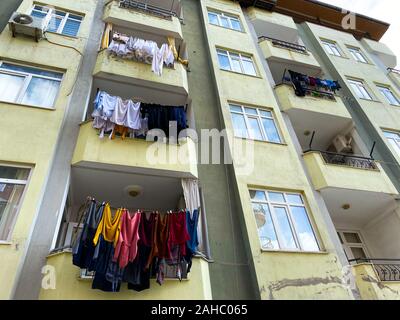 Kleider sind auf einem bolcon getrocknet. Fassade eines Wohnhauses. An der Fassade des Hauses ist eine Klimaanlage. Die Türkei. Alte Gebäude. Stockfoto
