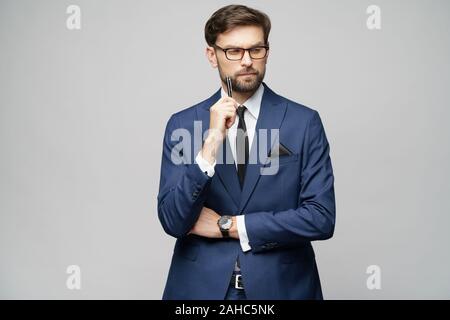 Studuo Schuss des Denkens Lösung Problem Geschäftsmann tragen Anzug halten Stift Stockfoto